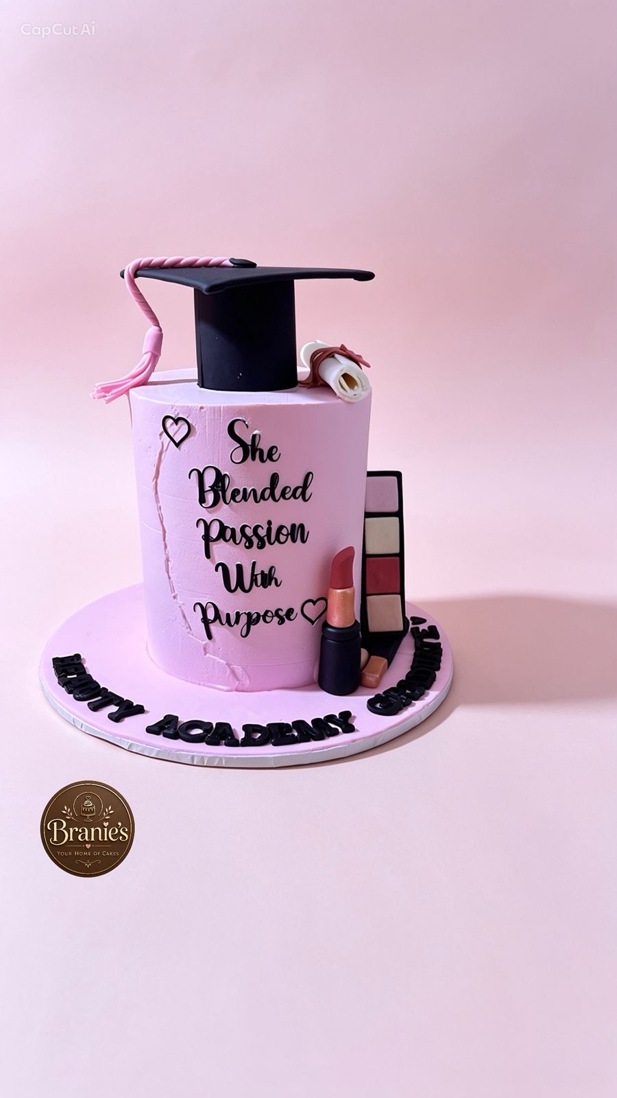 Pink graduation cake for a beauty academy