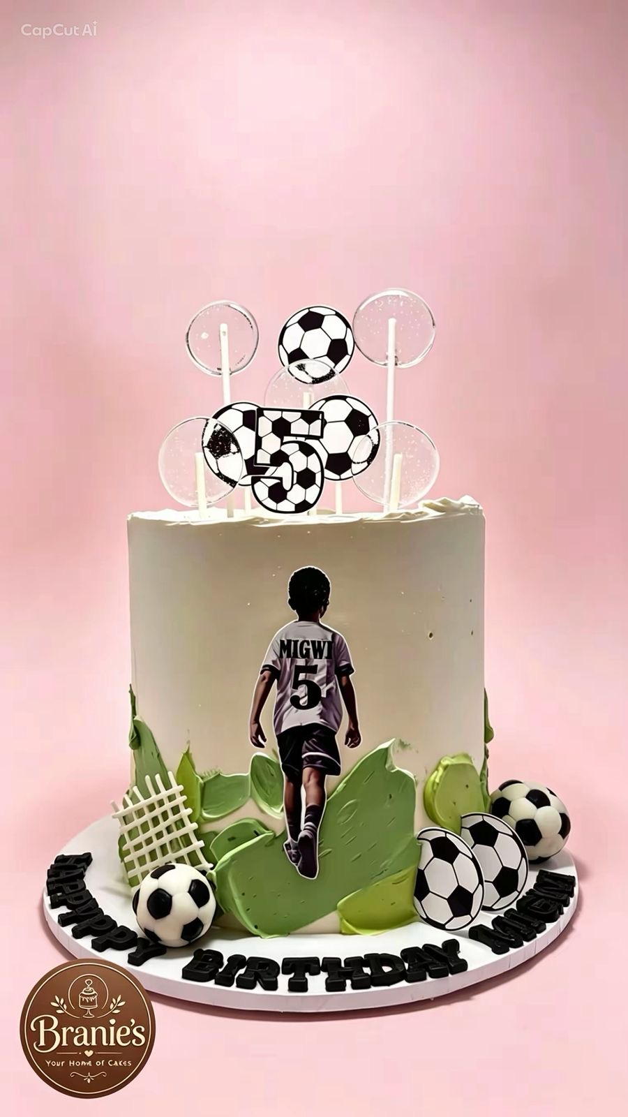 Soccer themed birthday cake with football toppers